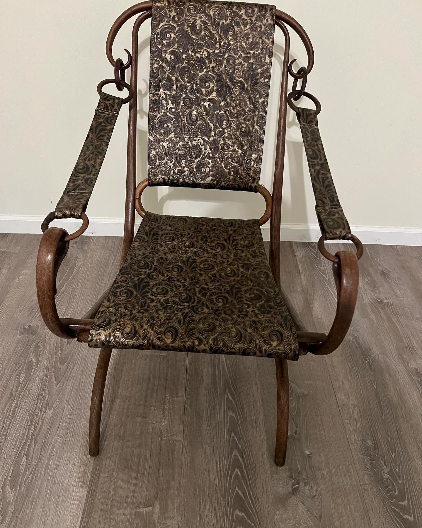 A chair is sitting on a wooden floor in a room.