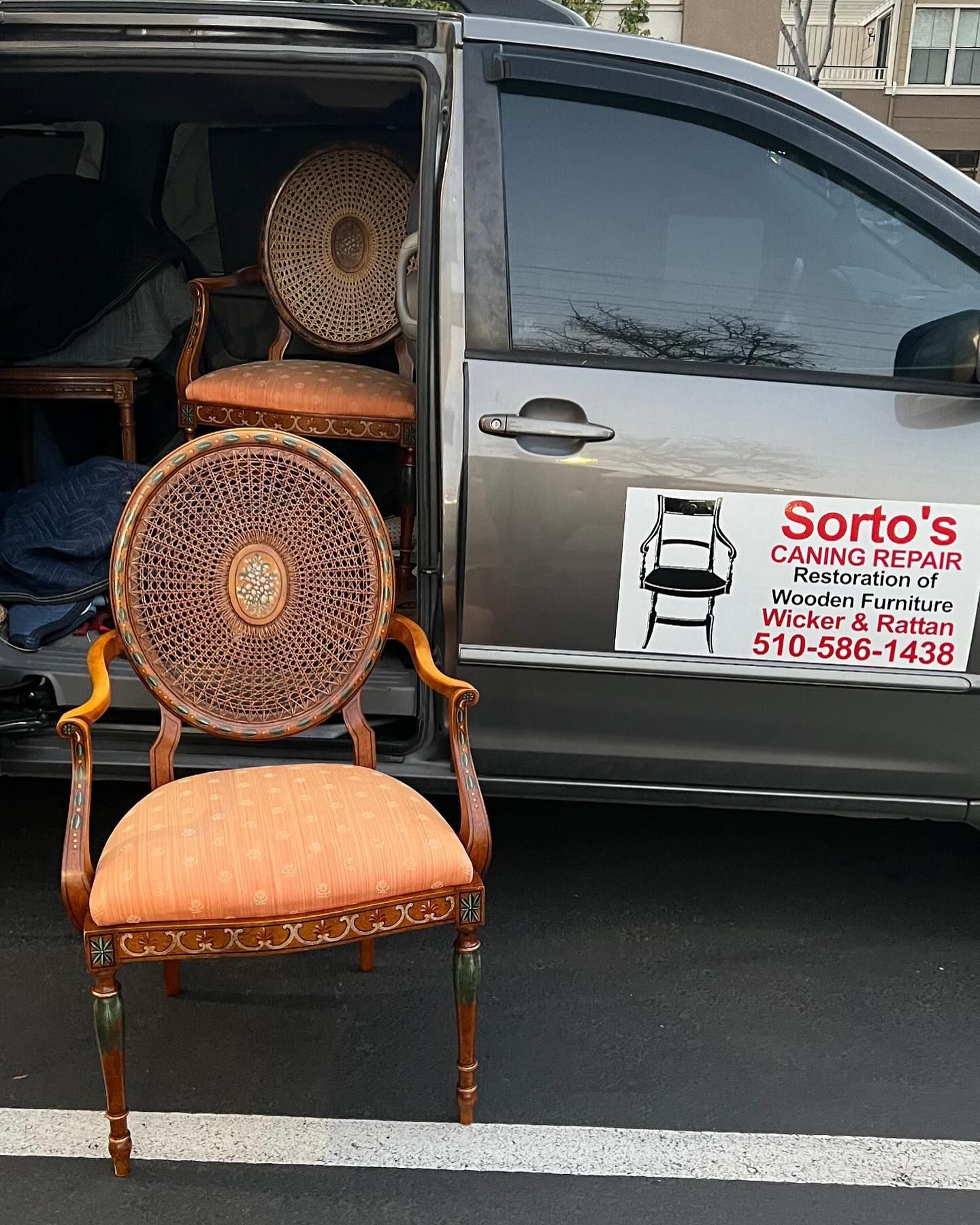 Two chairs are sitting in the back of a sorto 's van.