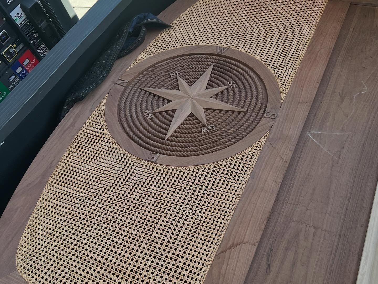 A wooden table with a compass on it
