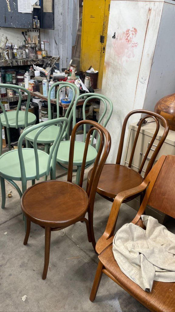 A group of wooden chairs sitting next to each other in a room.