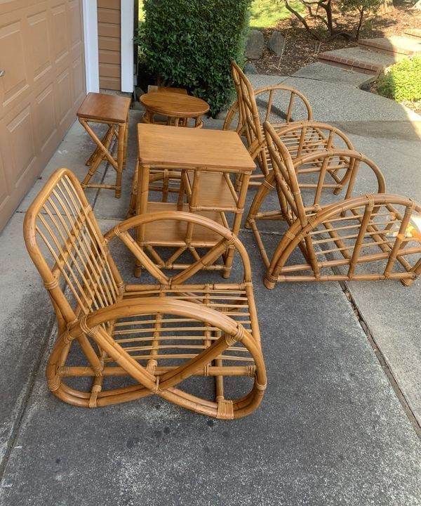 A set of wicker chairs and tables on a sidewalk