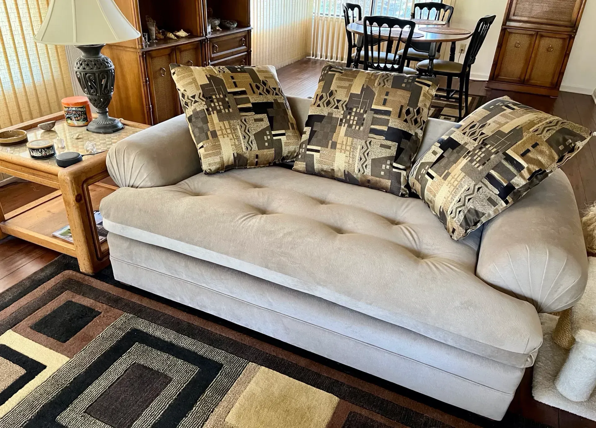 A living room with a couch and a lamp
