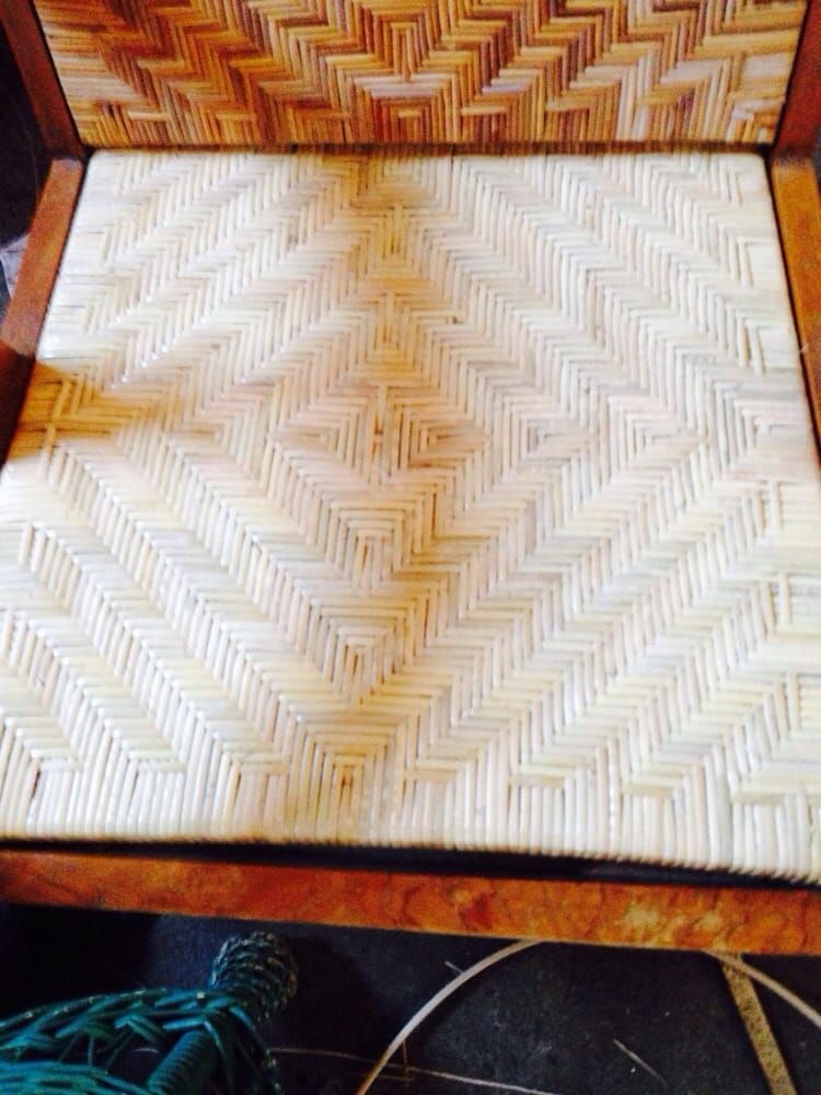 A wooden chair with a wicker seat and back