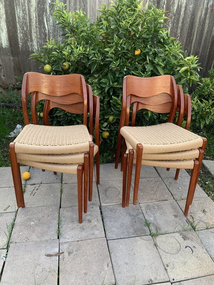 Four chairs are stacked on top of each other on a patio.