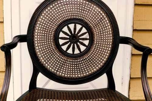 A chair with a wheel on it is sitting in front of a door.