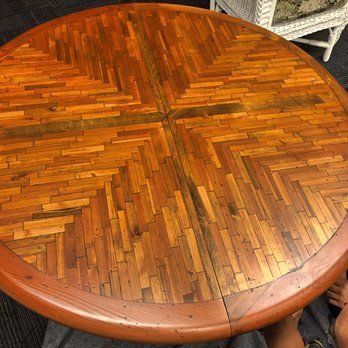 A round wooden table with a herringbone pattern on it.