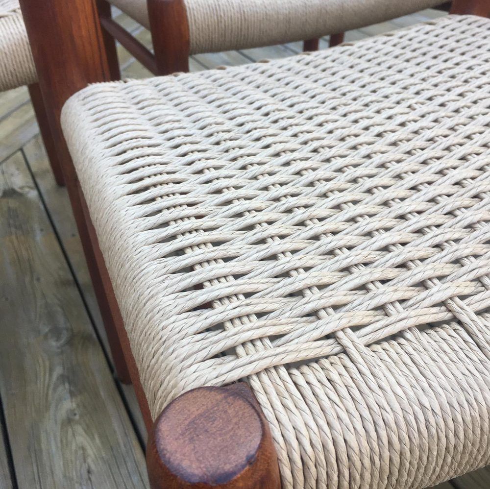 A close up of a wicker chair on a wooden deck