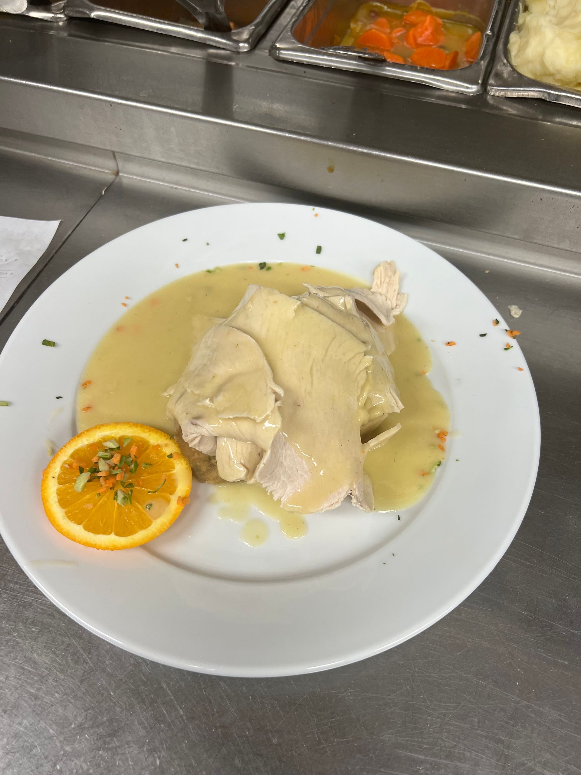 A plate of food with a slice of orange on it