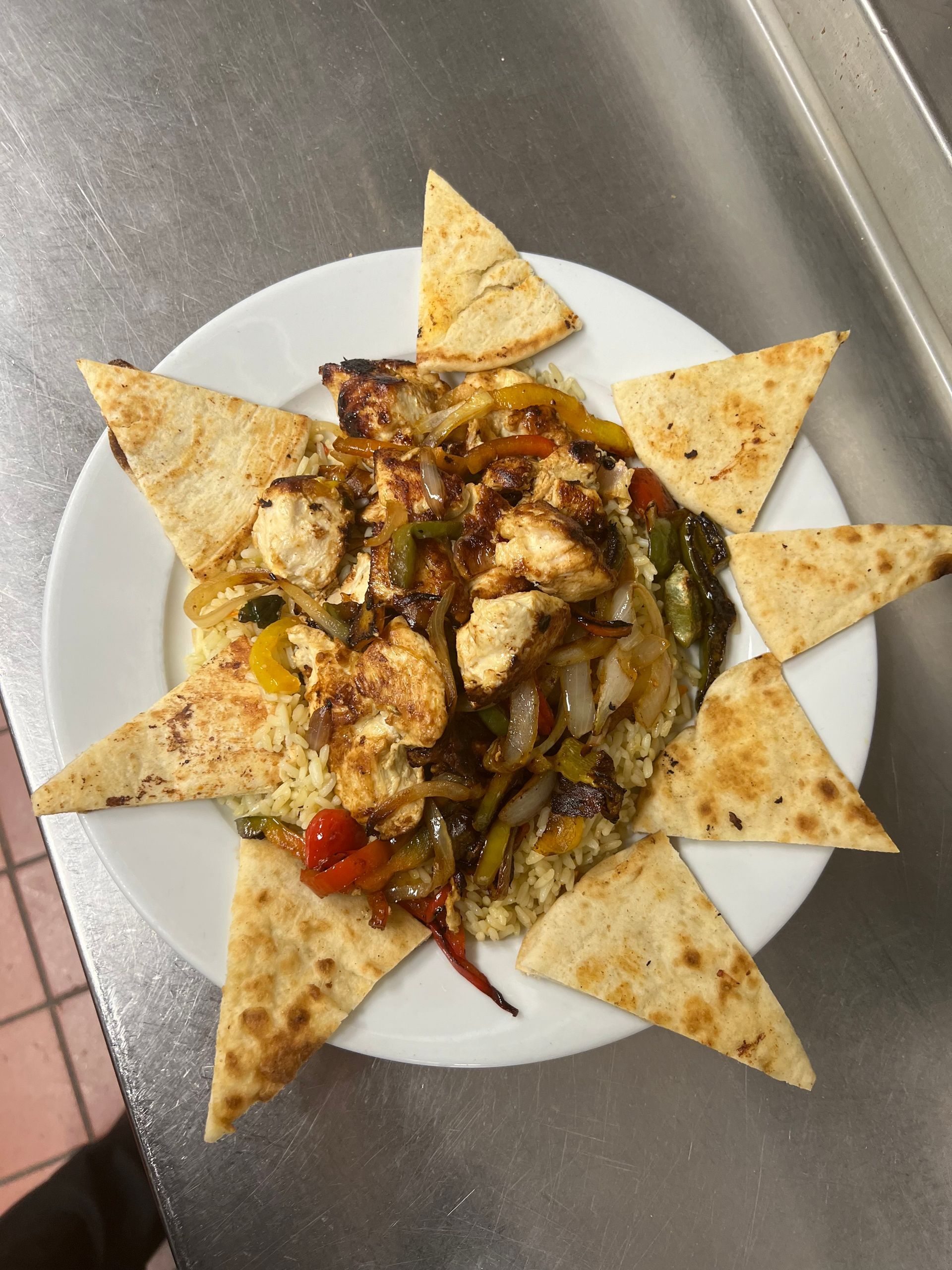 A plate of food with tortilla chips in the shape of a sun