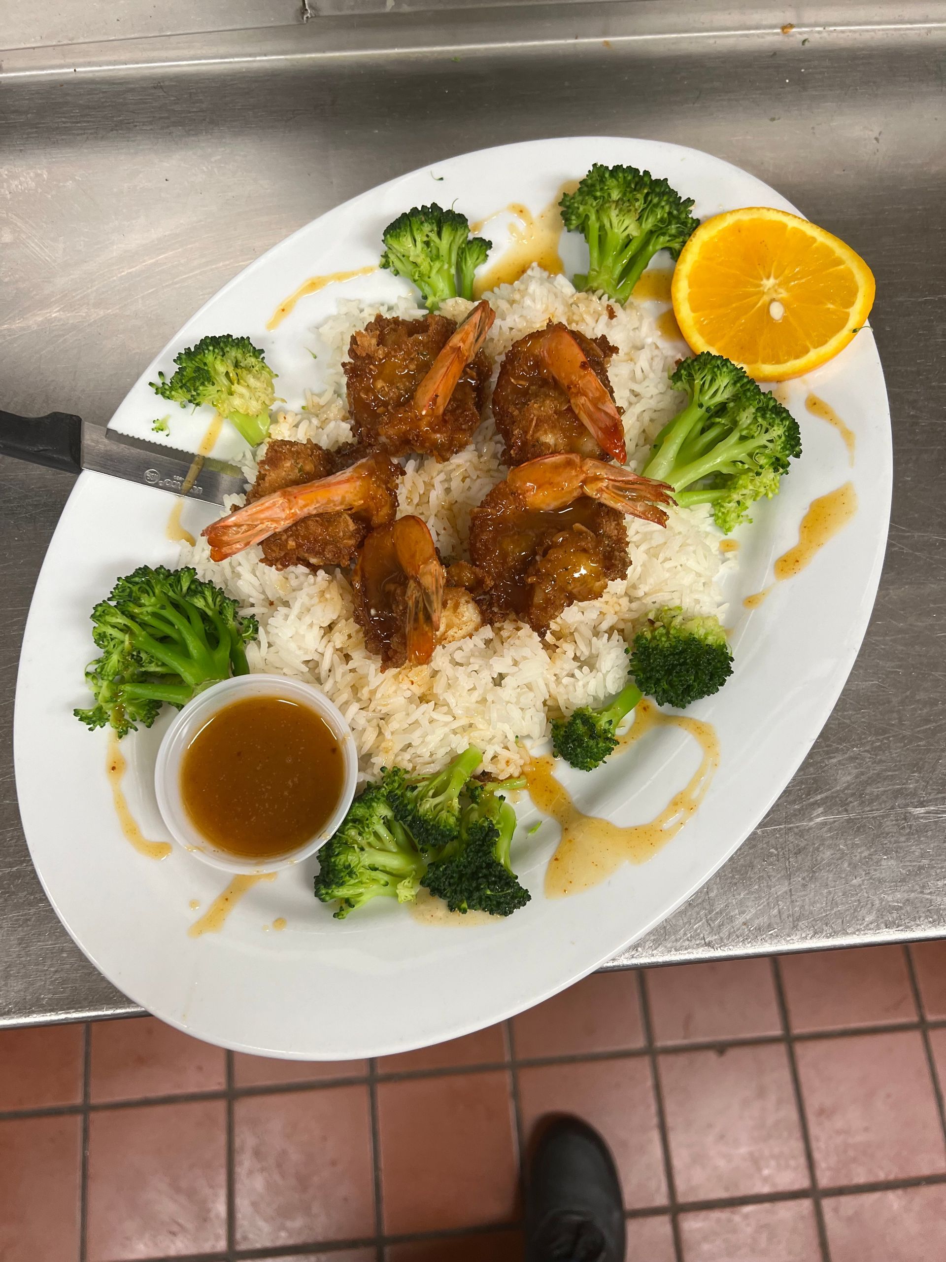 A plate of food with shrimp broccoli and rice