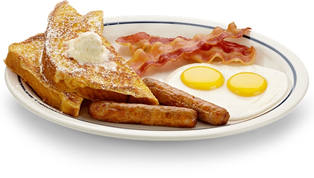 A white plate topped with french toast eggs bacon and sausages