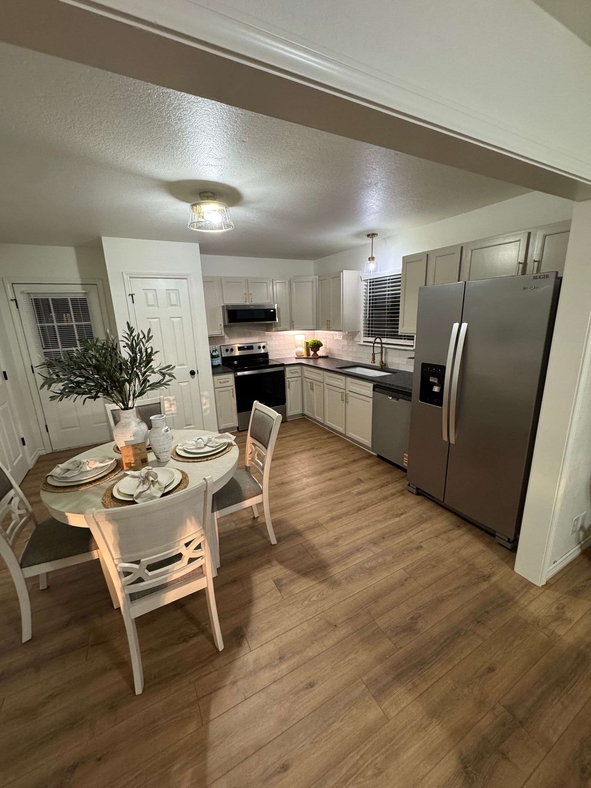 Kitchen with brown cabinets, stainless steel appliances, and island.