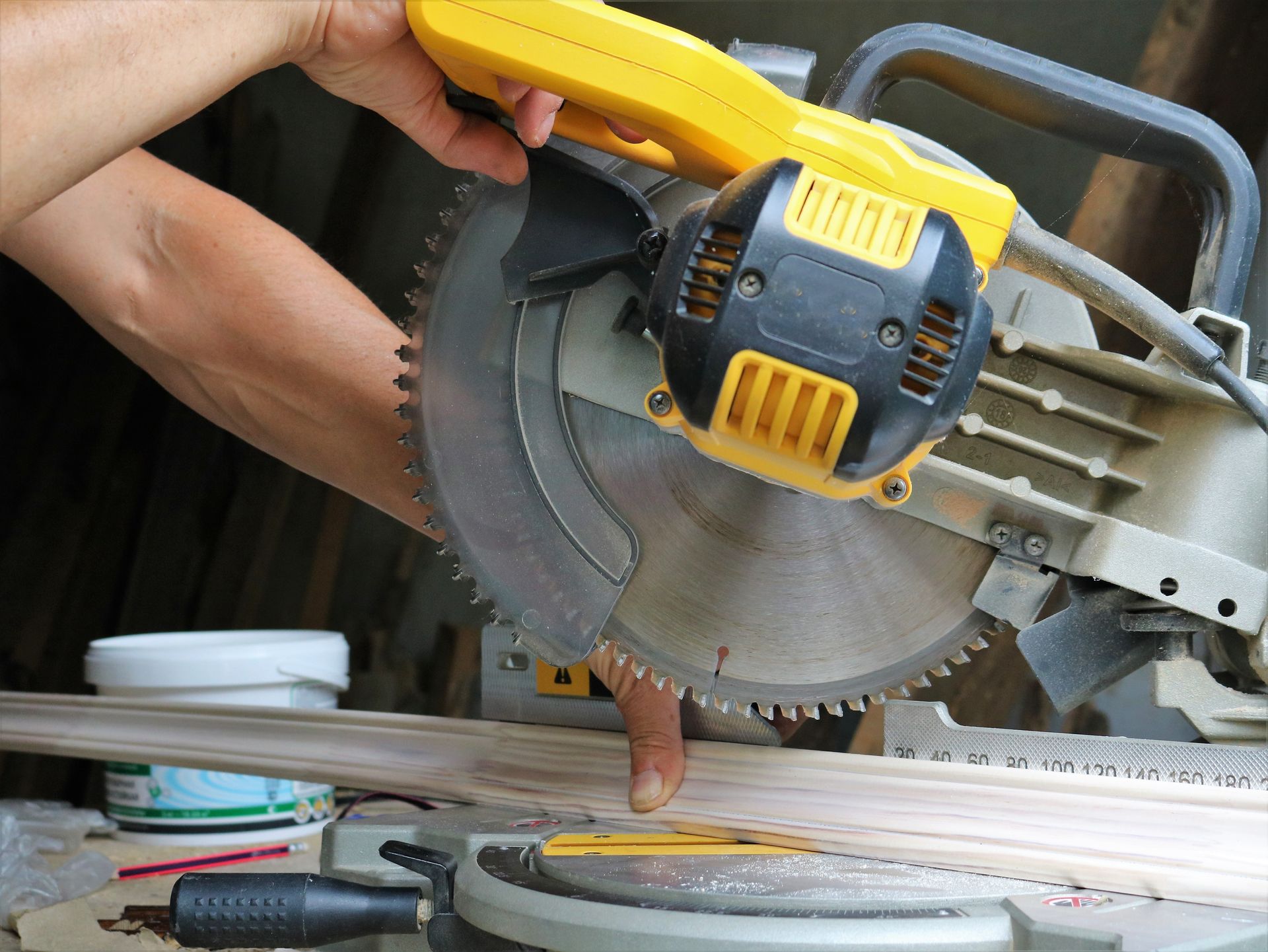 A house with solar panels on the roof is surrounded by trees.