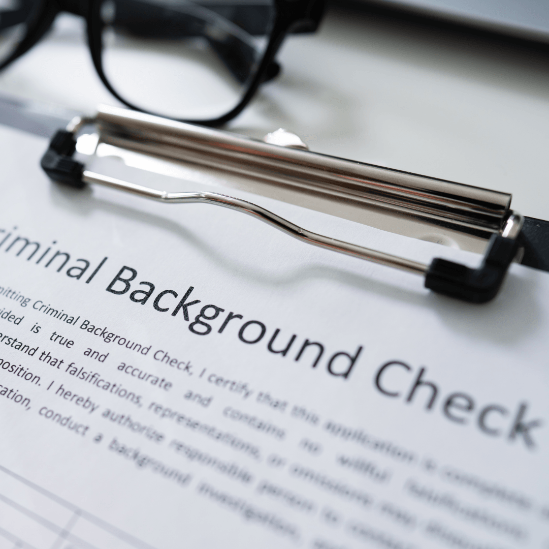 A clipboard with the words criminal background check on it