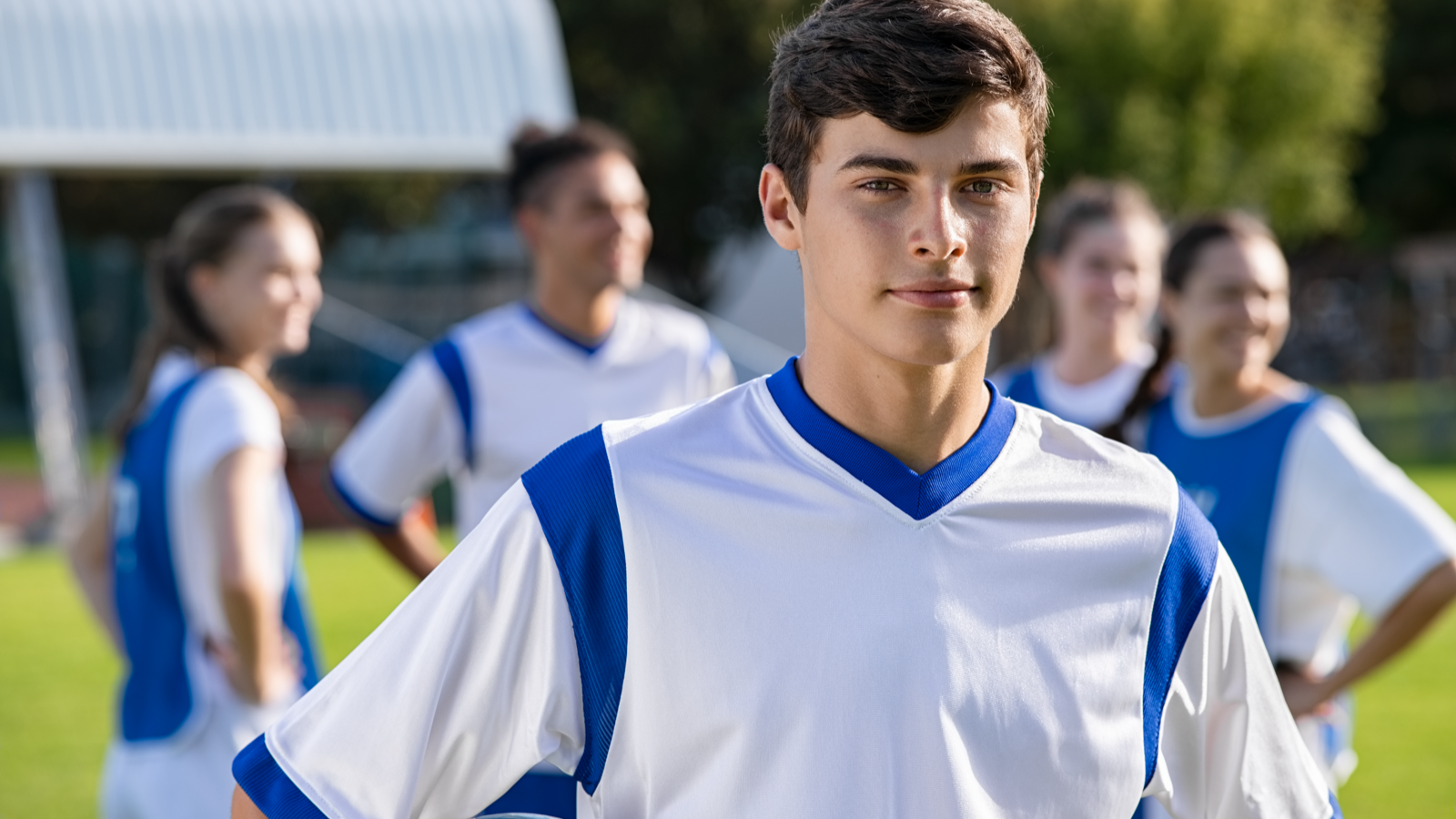 Soccer player standing with team