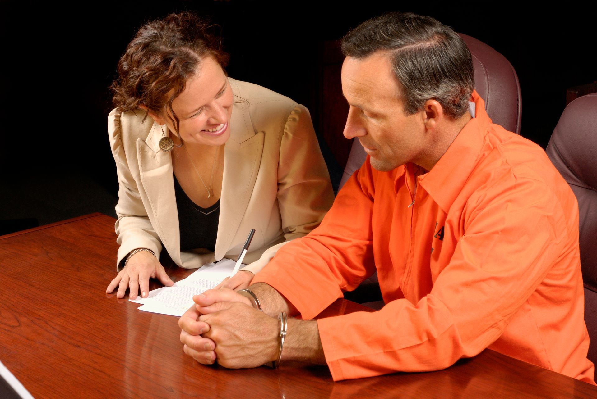 A lawyer is congratulating a client for securing bail bonds and achieving their release from jail.