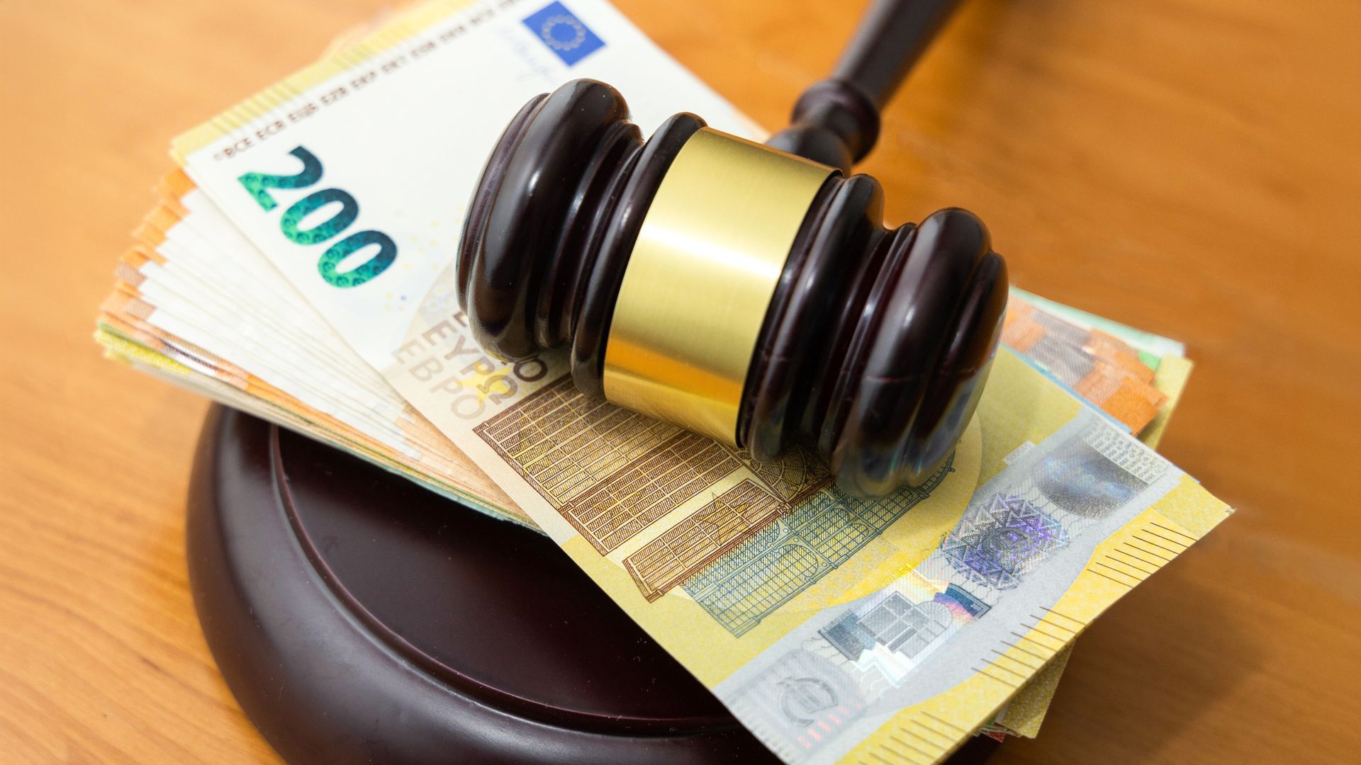 Judge's gavel on stack of banknotes.