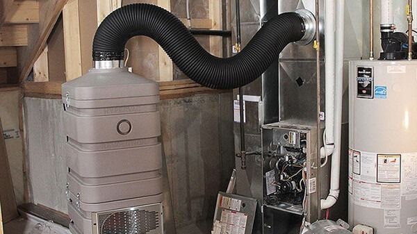 Furnace and water heater in a basement, with a flexible duct connecting to a unit.
