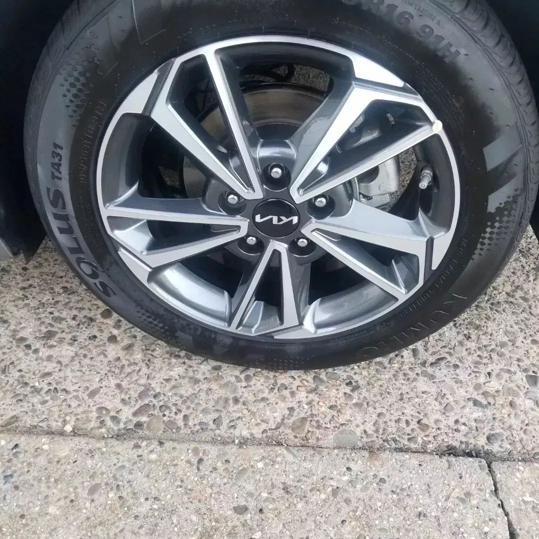 A close up of a car wheel on a concrete surface.