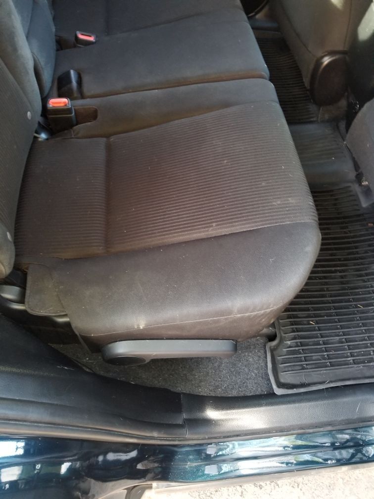 A close up of a car seat in the back of a car.