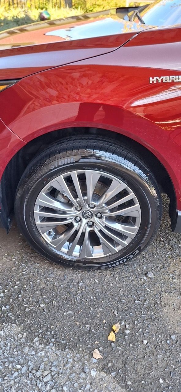 A red car is parked on the side of the road.