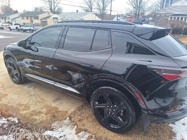 A black car with a steering wheel and a rear view mirror