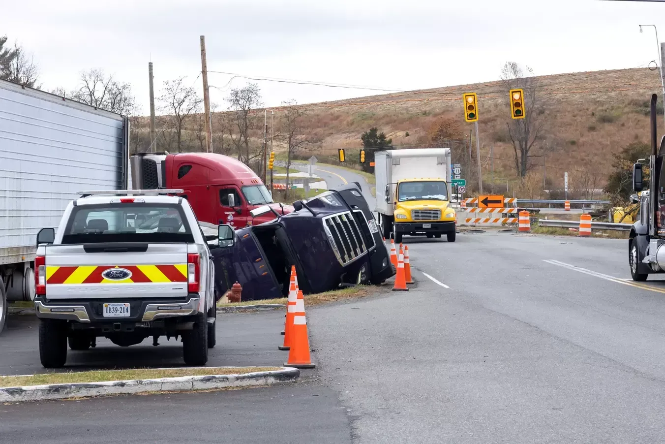 truck accident scene surrounded by orange cones