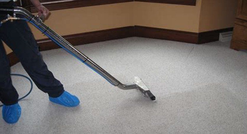 Male staff cleaning carpet