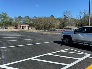 A silver truck is parked in a parking lot.