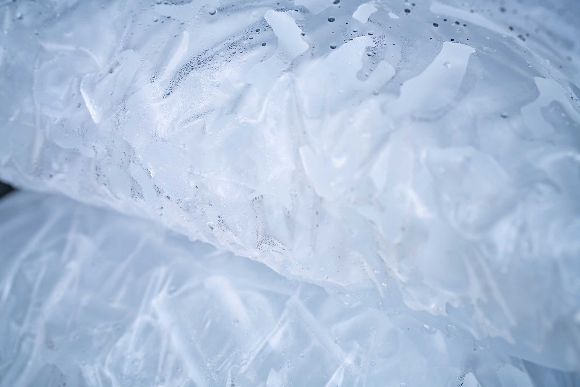 Close-up of tube ice inside two clear plastic bags.