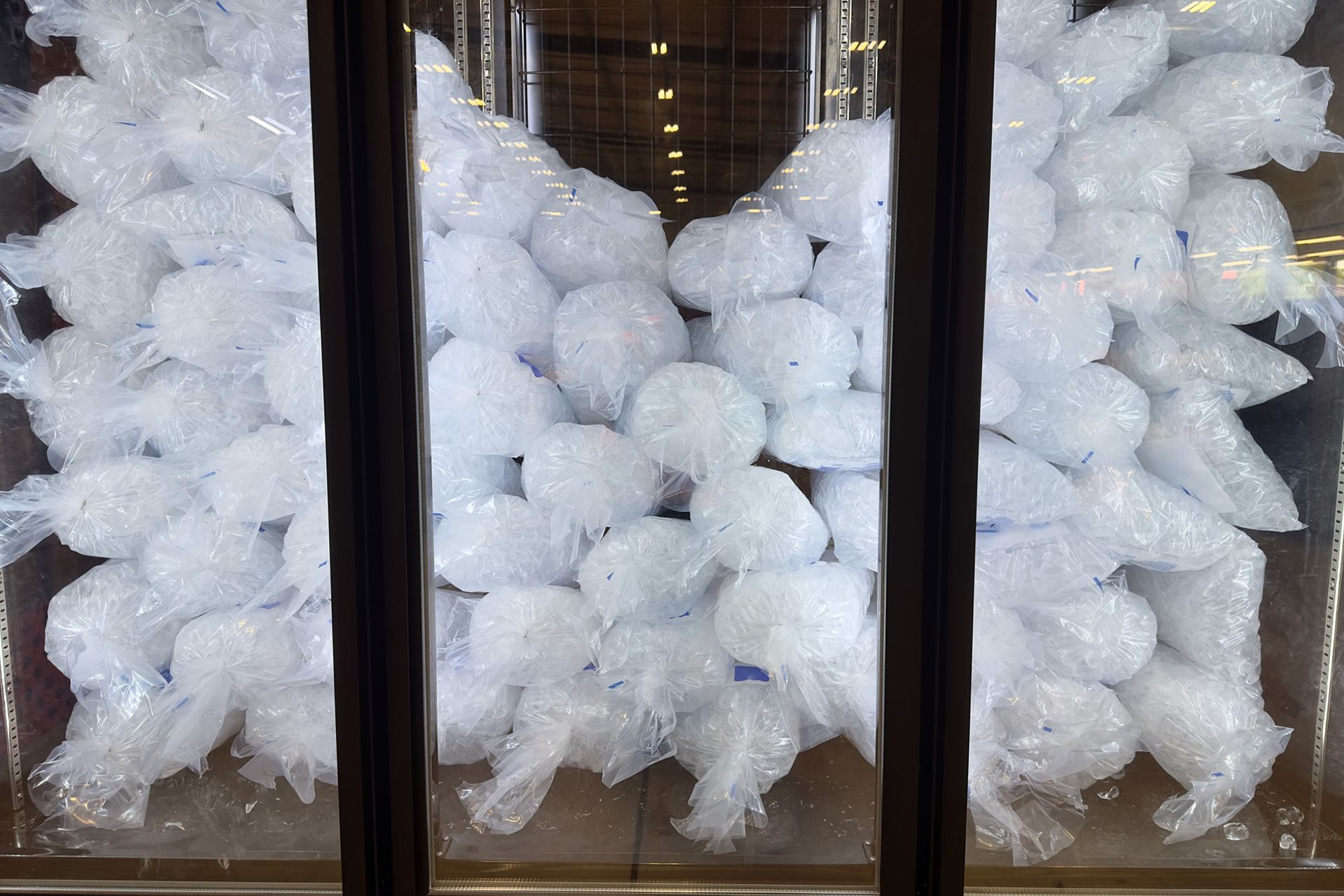 Bagged ice supply for sale inside a chiller.