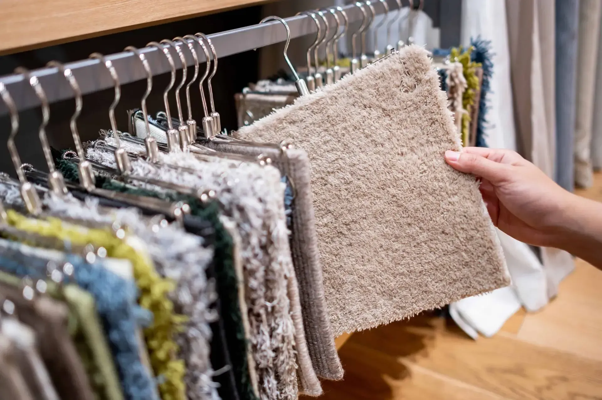 A person sifting through carpet samples to make a choice for their Richland home