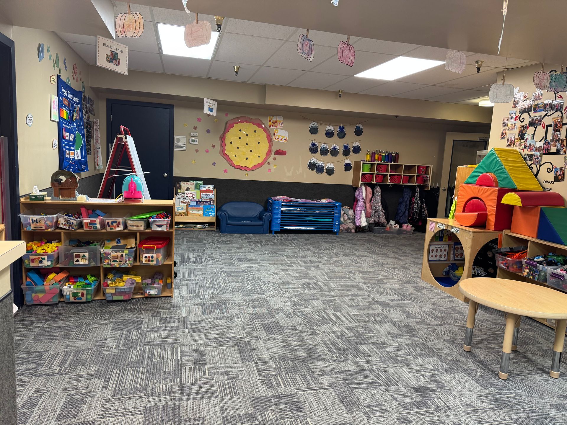 A children's playroom with toys, colorful blocks, and a small table.