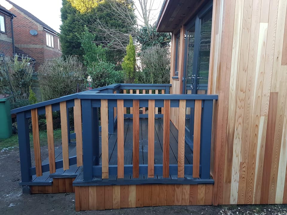 A wooden deck with stairs leading up to it