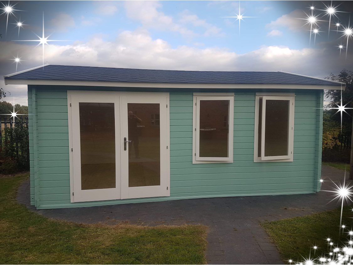 A small house with a blue roof and white windows