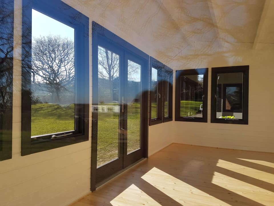 An empty room with a lot of windows and doors