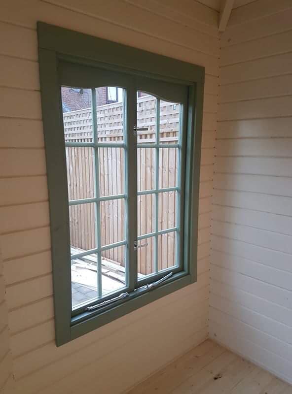There is a large window in the corner of the room.