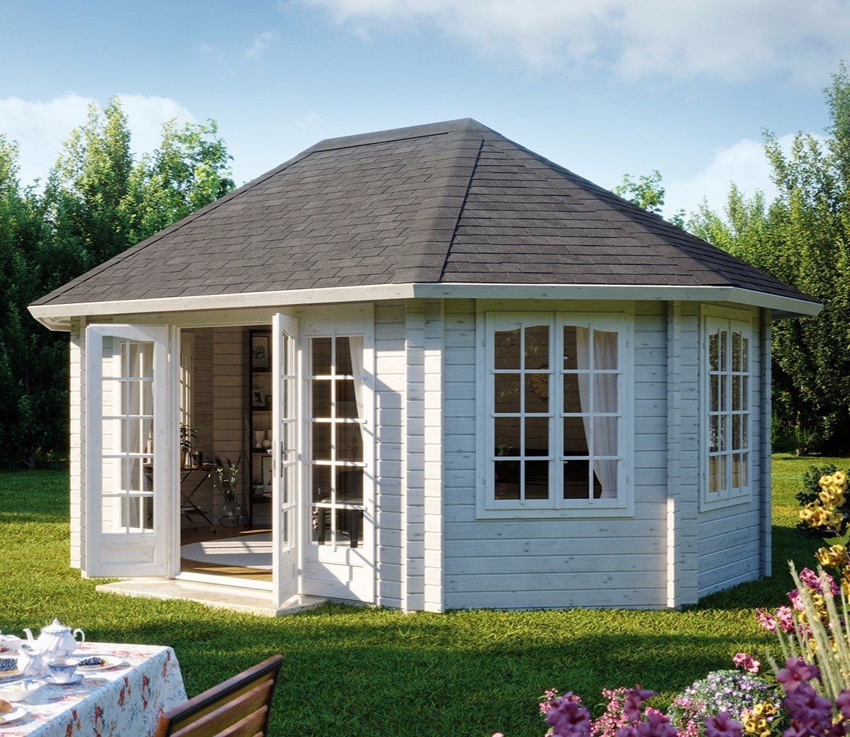 a white house with a gray roof and a table in front of it