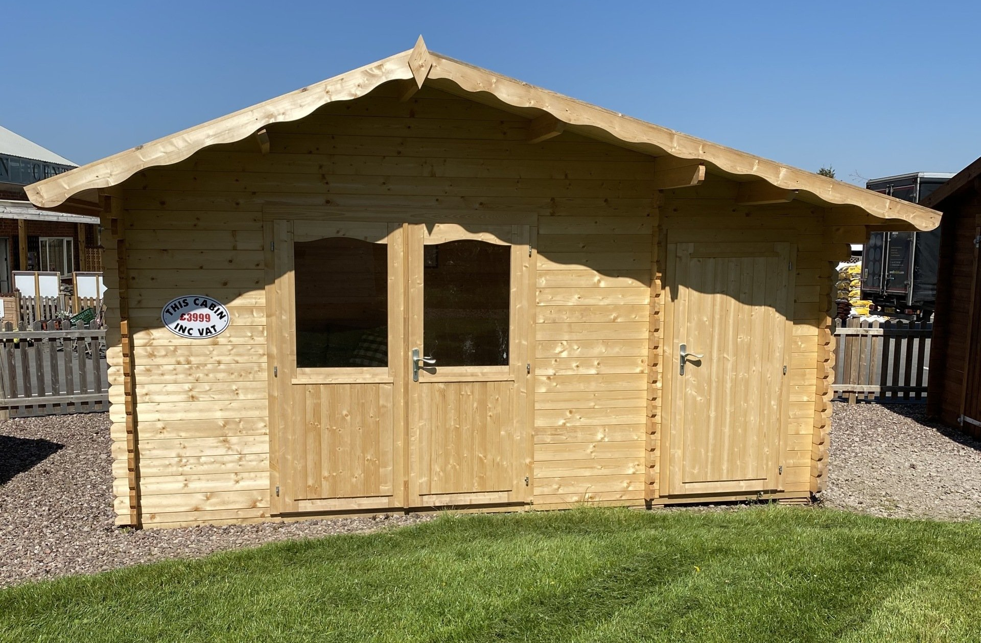 A small wooden house is sitting on top of a lush green lawn.
