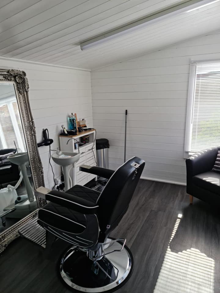 There is a barber chair in the middle of the room.