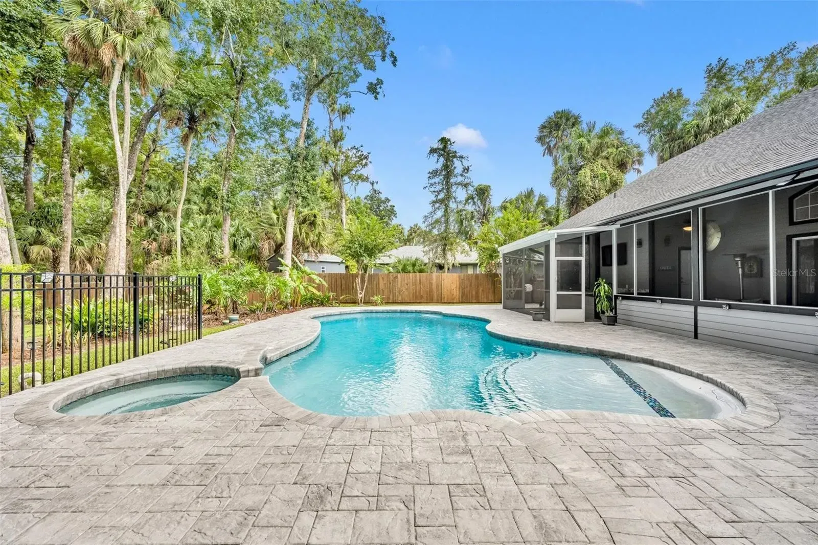 A large swimming pool in the backyard of a house