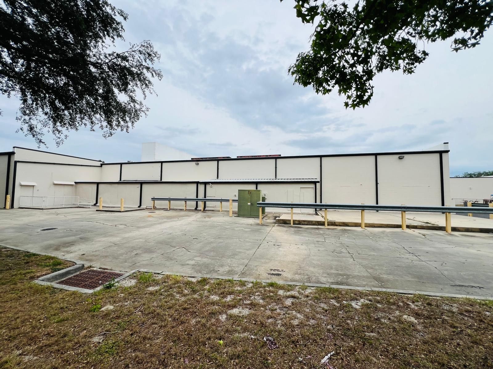 A large white building with a fence in front of it