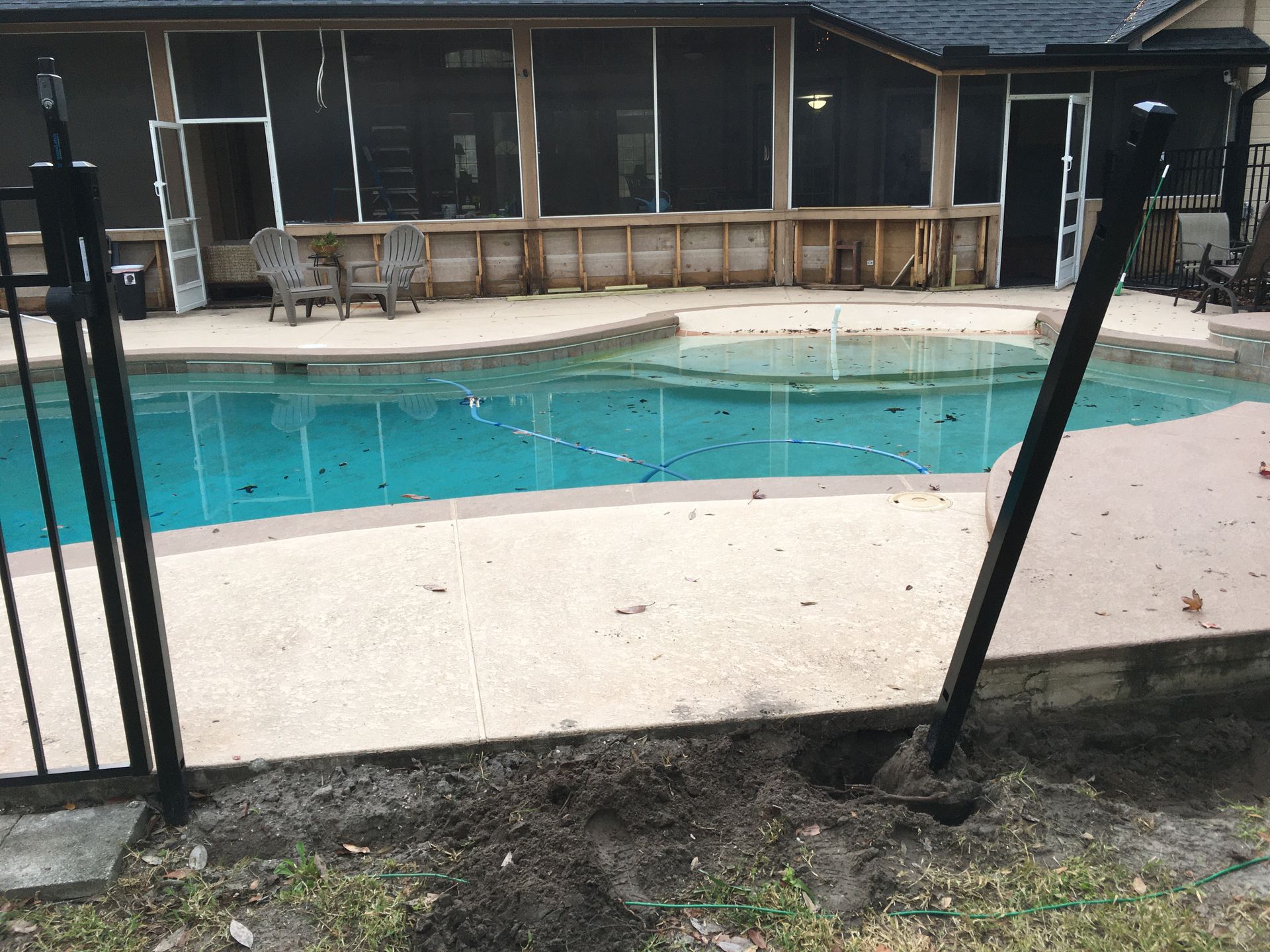 A house with a screened in porch and a swimming pool
