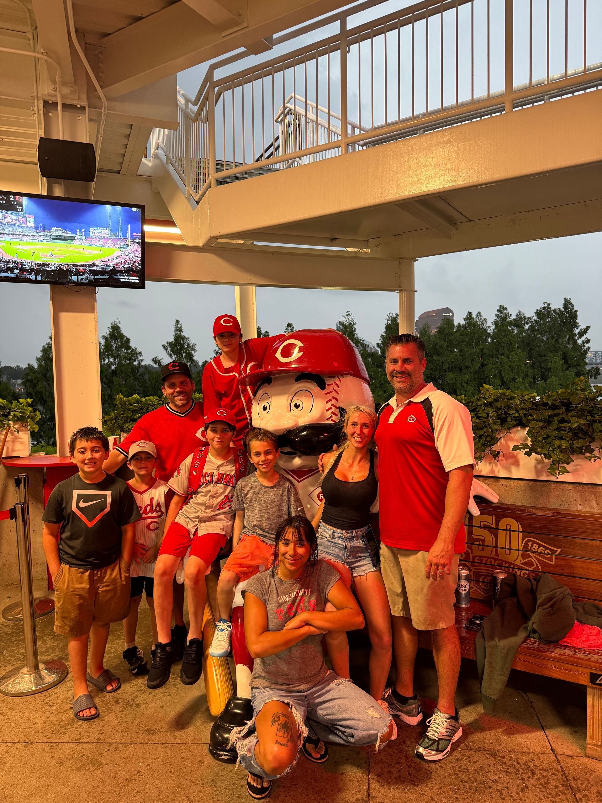 A group of people are posing for a picture with a mascot.