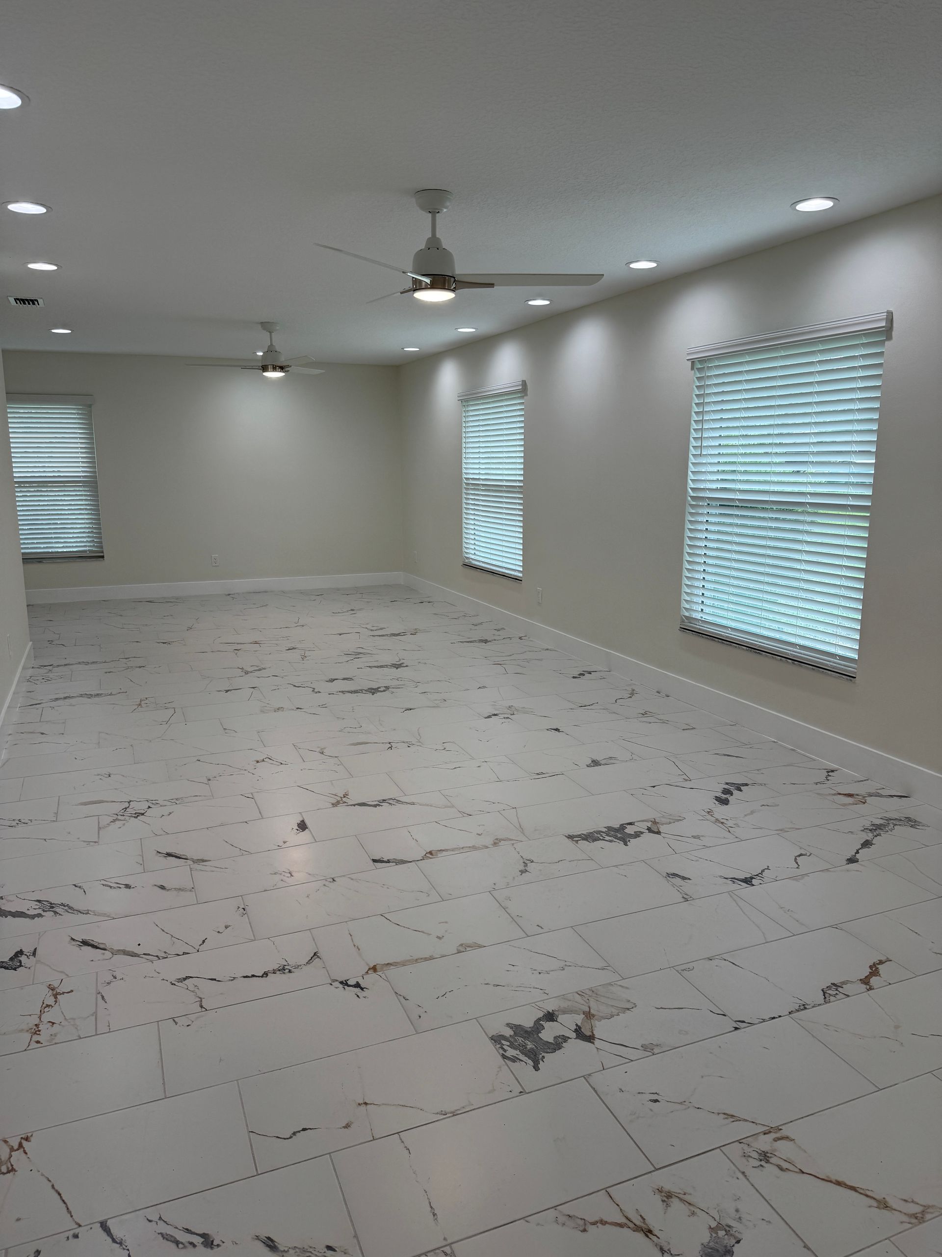 A living room with a couch , chair , table and rug.