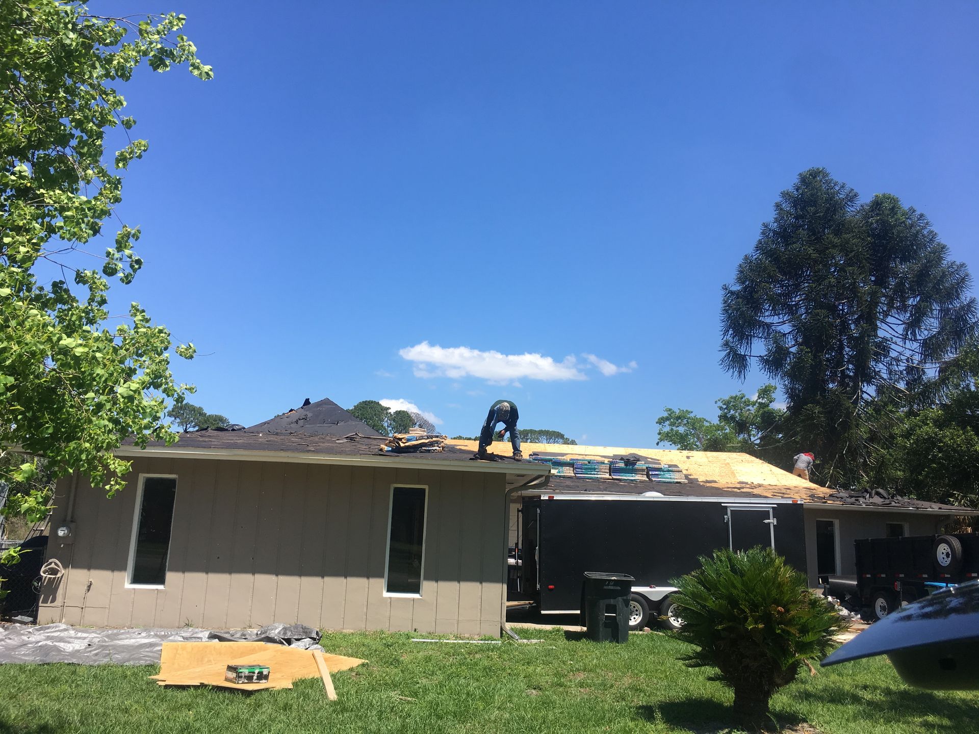 A man is working on the roof of a house.