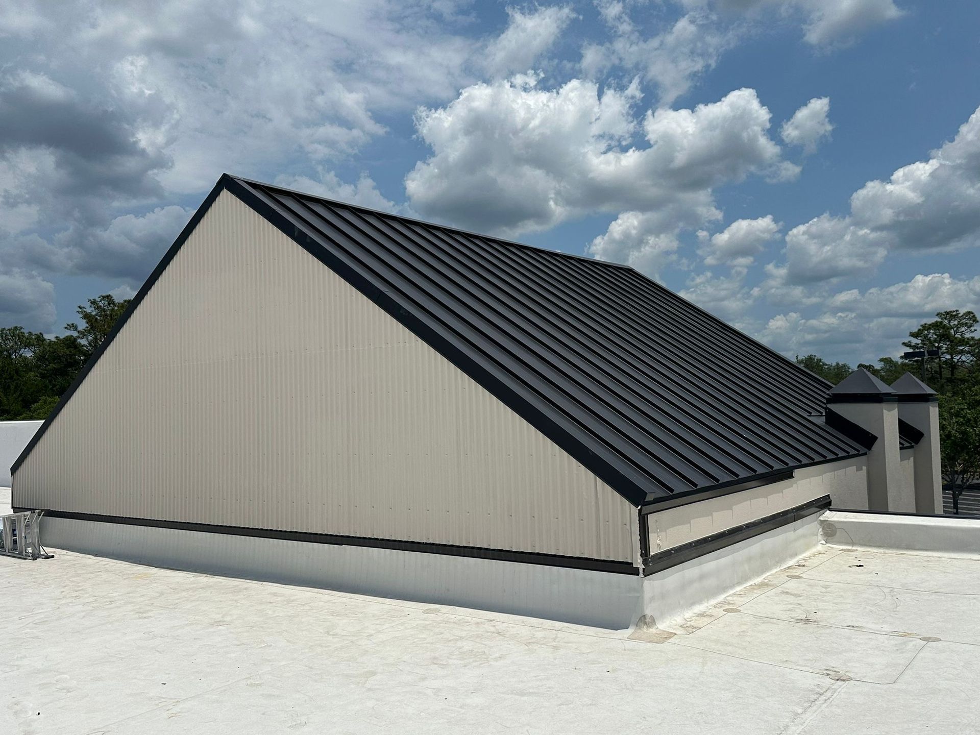 A building with a black roof and a white roof