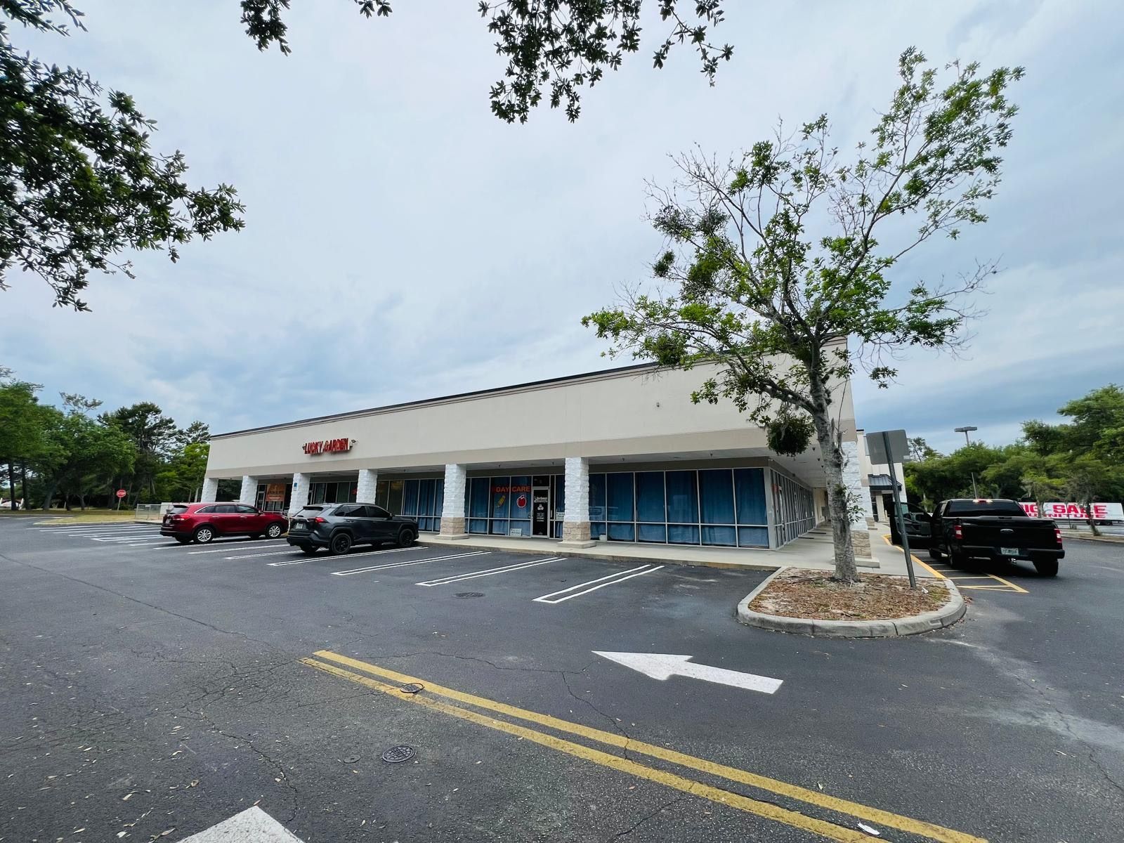 A parking lot with cars parked in front of a building