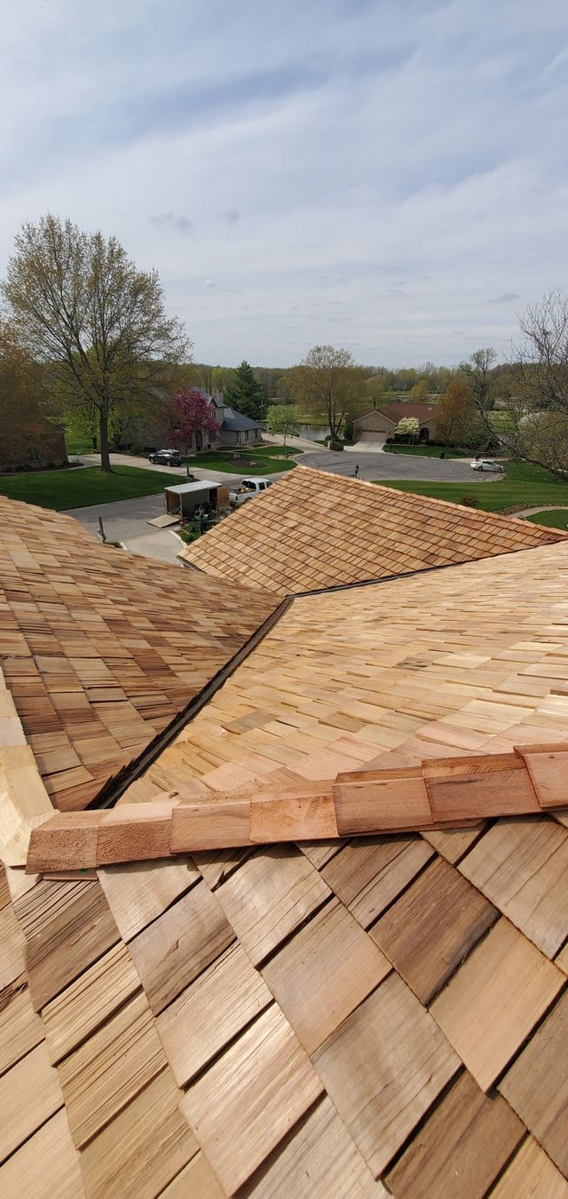 A wooden roof is being installed on a house.