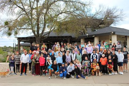 A group of people are posing for a picture on a golf course.